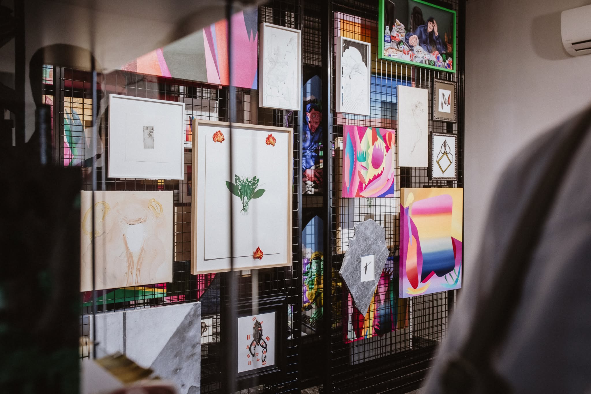 A selection of artworks displayed on gallery racks